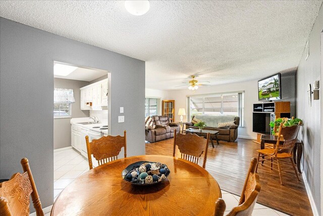 909 Savannas Point Dr Unit A, Fort Pierce, FL 34982 - dining area featuring light tile patterned floors, a textured ceiling, and a ceiling fan
