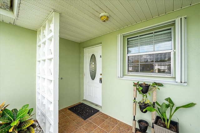 909 Savannas Point Dr Unit A, Fort Pierce, FL 34982 - view of exterior entry featuring stucco siding and covered porch