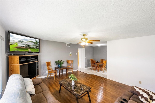 909 Savannas Point Dr Unit A, Fort Pierce, FL 34982 - living room featuring a ceiling fan, a textured ceiling, and wood finished floors