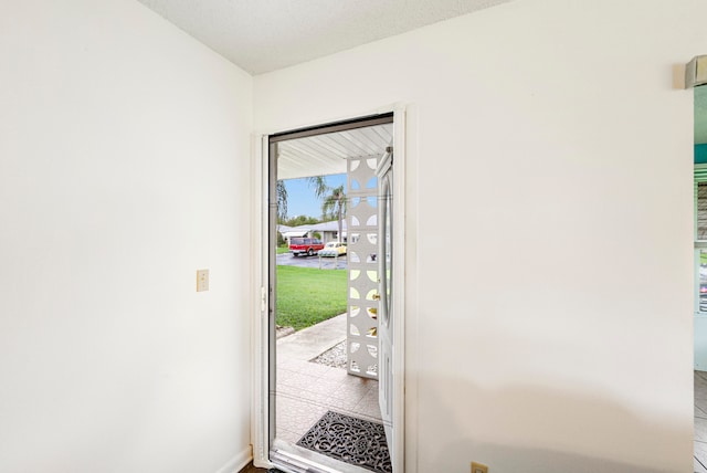 doorway to outside featuring tile patterned floors