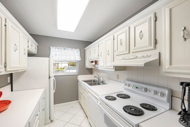 kitchen featuring light tile patterned flooring, backsplash, sink, white cabinets, and white appliances