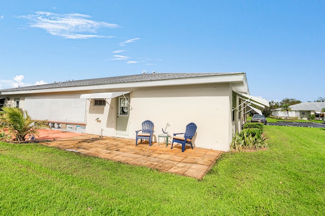 rear view of property with a patio and a yard