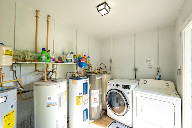 clothes washing area featuring electric water heater and washing machine and clothes dryer