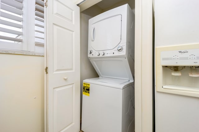 laundry room featuring stacked washer and clothes dryer