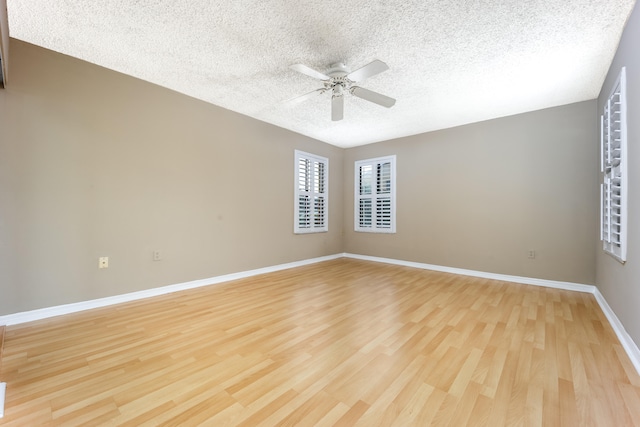 spare room featuring ceiling fan, a textured ceiling, and light wood-type flooring