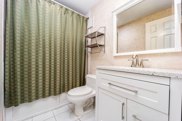 full bathroom with tile patterned floors, shower / tub combo with curtain, vanity, and toilet