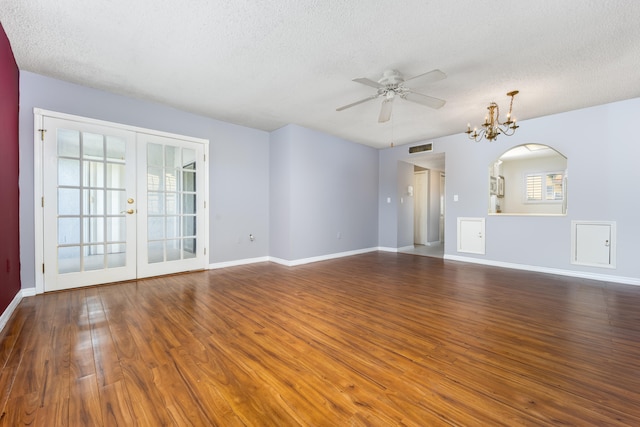 unfurnished living room featuring dark hardwood / wood-style floors, a textured ceiling, and ceiling fan with notable chandelier