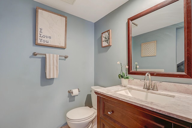 half bath with vanity and toilet