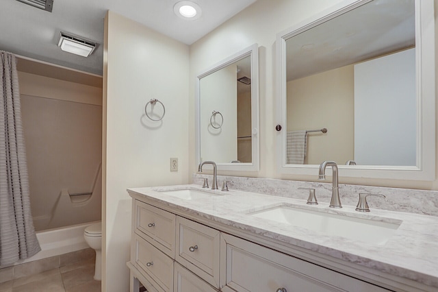 bathroom featuring walk in shower, tile patterned flooring, vanity, and toilet