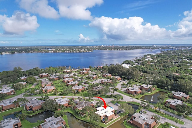 birds eye view of property with a water view and a residential view