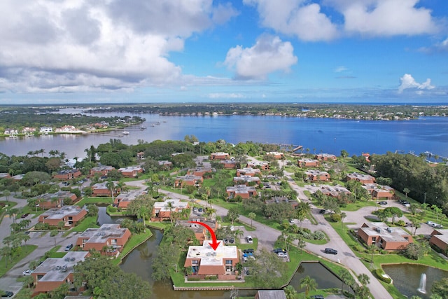 drone / aerial view featuring a water view and a residential view