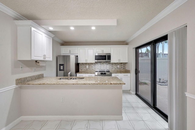 kitchen featuring kitchen peninsula, white cabinetry, sink, and appliances with stainless steel finishes