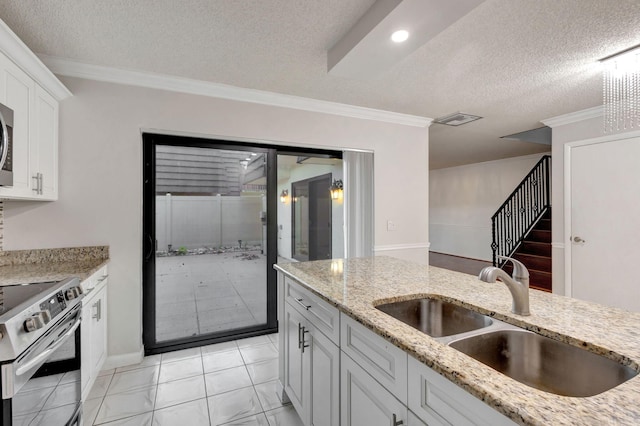 kitchen with white cabinets, stainless steel electric range, sink, and a textured ceiling