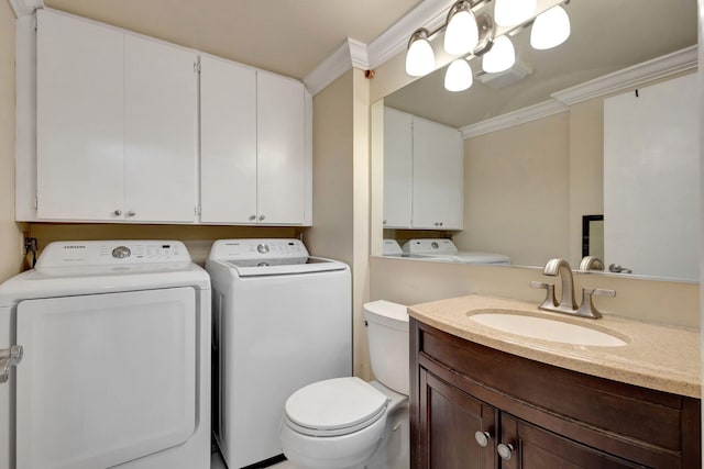 bathroom with crown molding, vanity, washer and dryer, and toilet