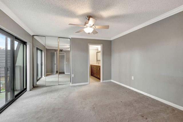 unfurnished bedroom featuring light carpet, a textured ceiling, a closet, and ceiling fan