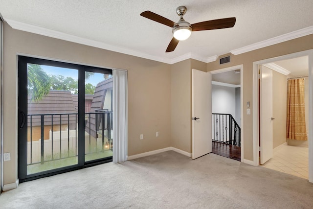 unfurnished room with light carpet, a textured ceiling, ceiling fan, and ornamental molding