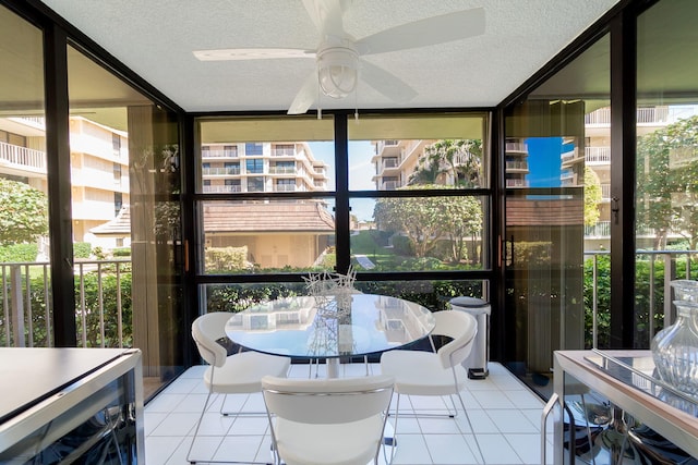 sunroom with plenty of natural light, ceiling fan, and wine cooler