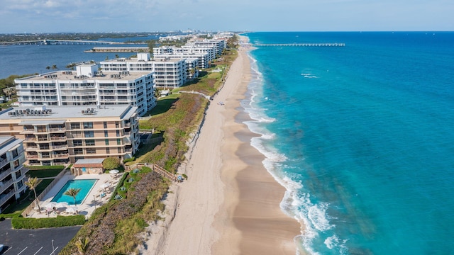 drone / aerial view with a beach view and a water view