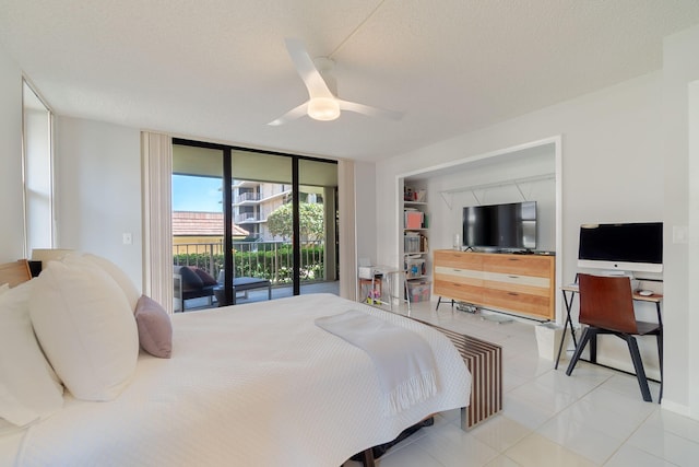 bedroom with ceiling fan, a textured ceiling, tile patterned floors, and access to outside