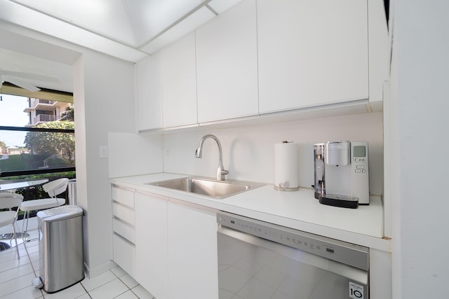 kitchen featuring stainless steel dishwasher, white cabinetry, and sink