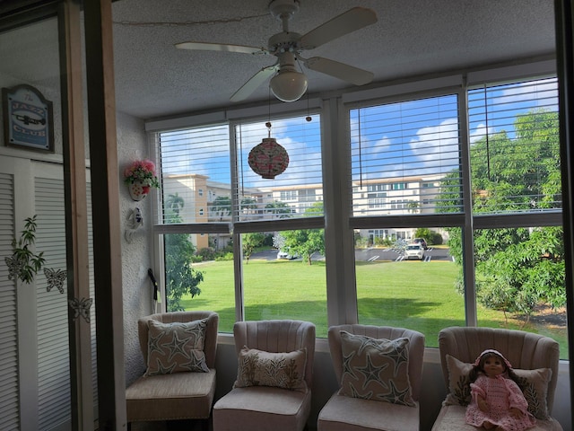 sunroom featuring ceiling fan