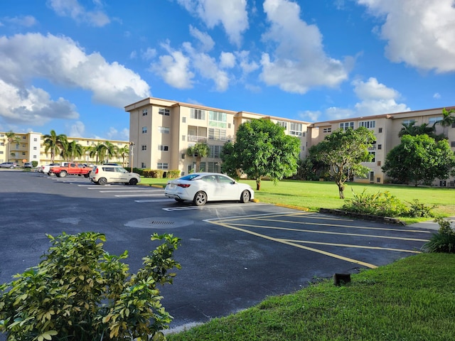 view of parking featuring a yard