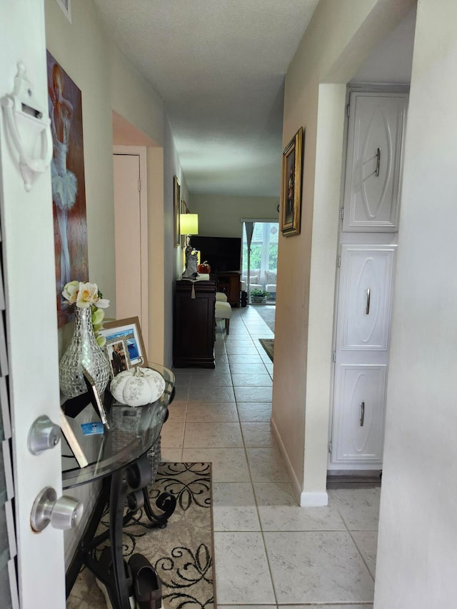 hallway featuring light tile patterned floors