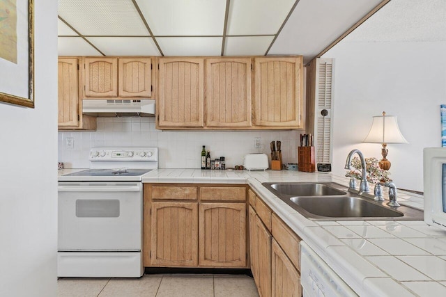 kitchen with sink, tile counters, white electric range, decorative backsplash, and light tile patterned flooring