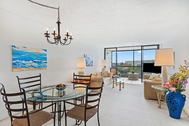 dining space featuring carpet flooring, a textured ceiling, an inviting chandelier, and expansive windows