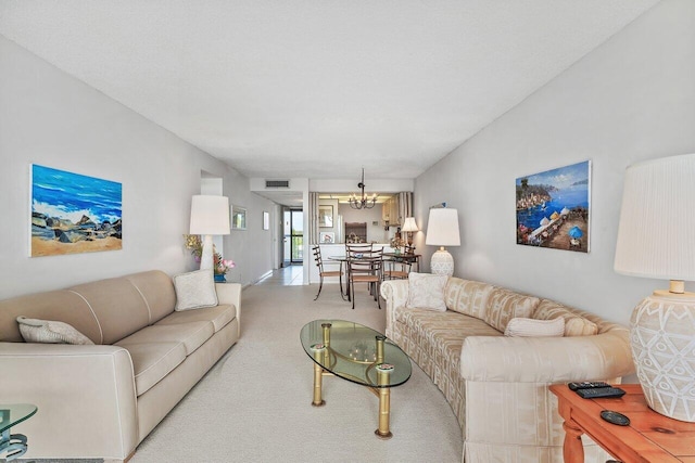 living room with light colored carpet and an inviting chandelier