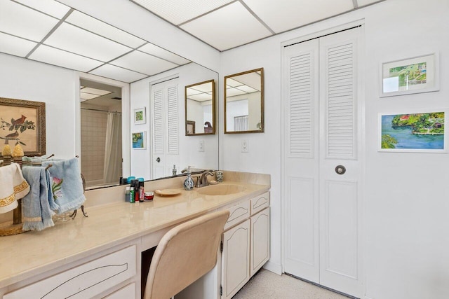 bathroom with vanity, a shower with curtain, and a paneled ceiling