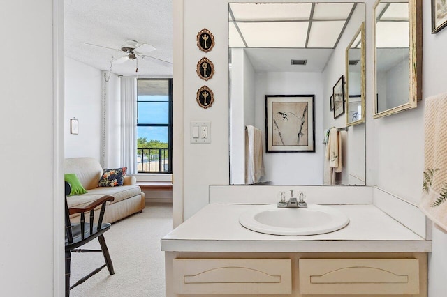 bathroom with vanity, a textured ceiling, and ceiling fan