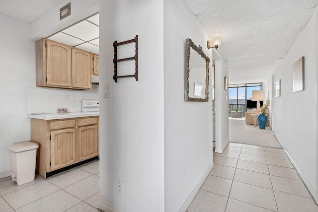 corridor featuring floor to ceiling windows and light tile patterned floors