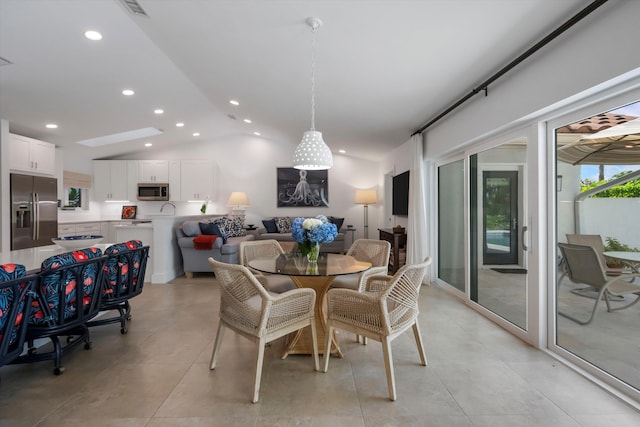 dining space with vaulted ceiling