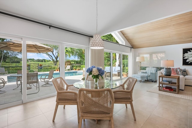 tiled dining area featuring wood ceiling and vaulted ceiling