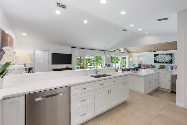 kitchen featuring dishwasher, white cabinets, sink, vaulted ceiling, and light tile patterned floors