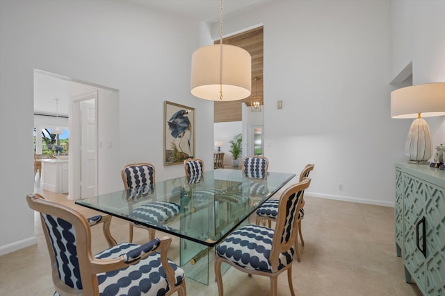 dining space featuring a towering ceiling