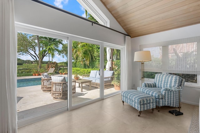 interior space featuring a wealth of natural light, light tile patterned floors, wood ceiling, and lofted ceiling