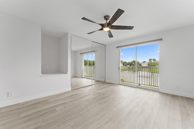 empty room with ceiling fan and light wood-type flooring