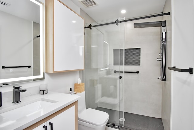 bathroom with vanity, toilet, and walk in shower