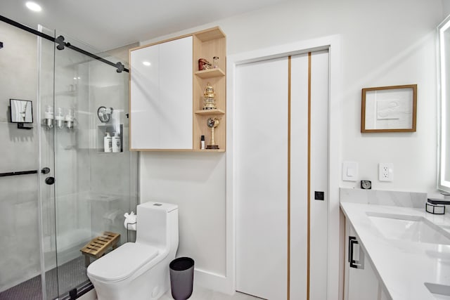 bathroom featuring vanity, toilet, and an enclosed shower