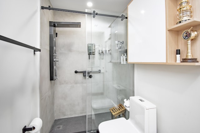 bathroom featuring walk in shower and toilet