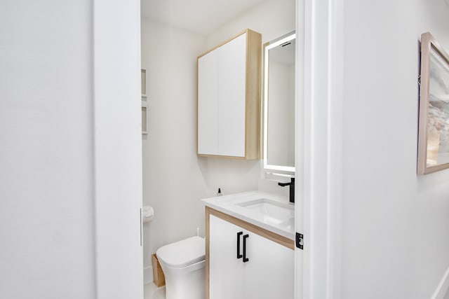 bathroom featuring vanity and toilet