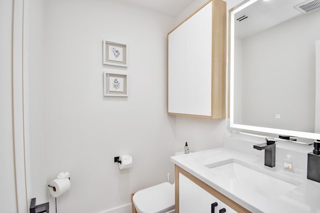 bathroom with vanity and toilet