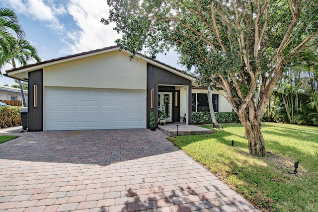 ranch-style house with a front yard and a garage