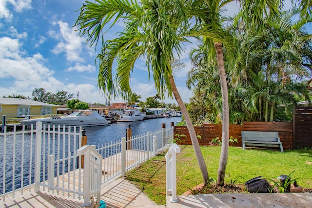 dock area featuring a yard and a water view