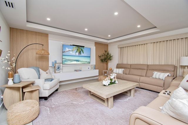 living room featuring a raised ceiling