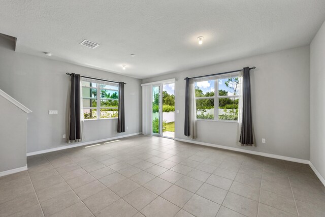 3526 Joshua Tree St, Palm Springs, FL 33461 - unfurnished room featuring light tile patterned floors, a textured ceiling, baseboards, and a smoke detector