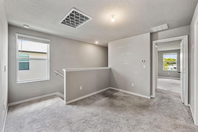 3526 Joshua Tree St, Palm Springs, FL 33461 - carpeted spare room with a textured ceiling and baseboards