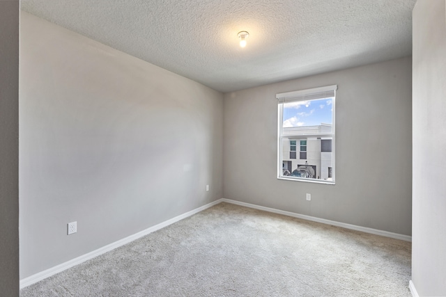 unfurnished room featuring a textured ceiling and carpet floors